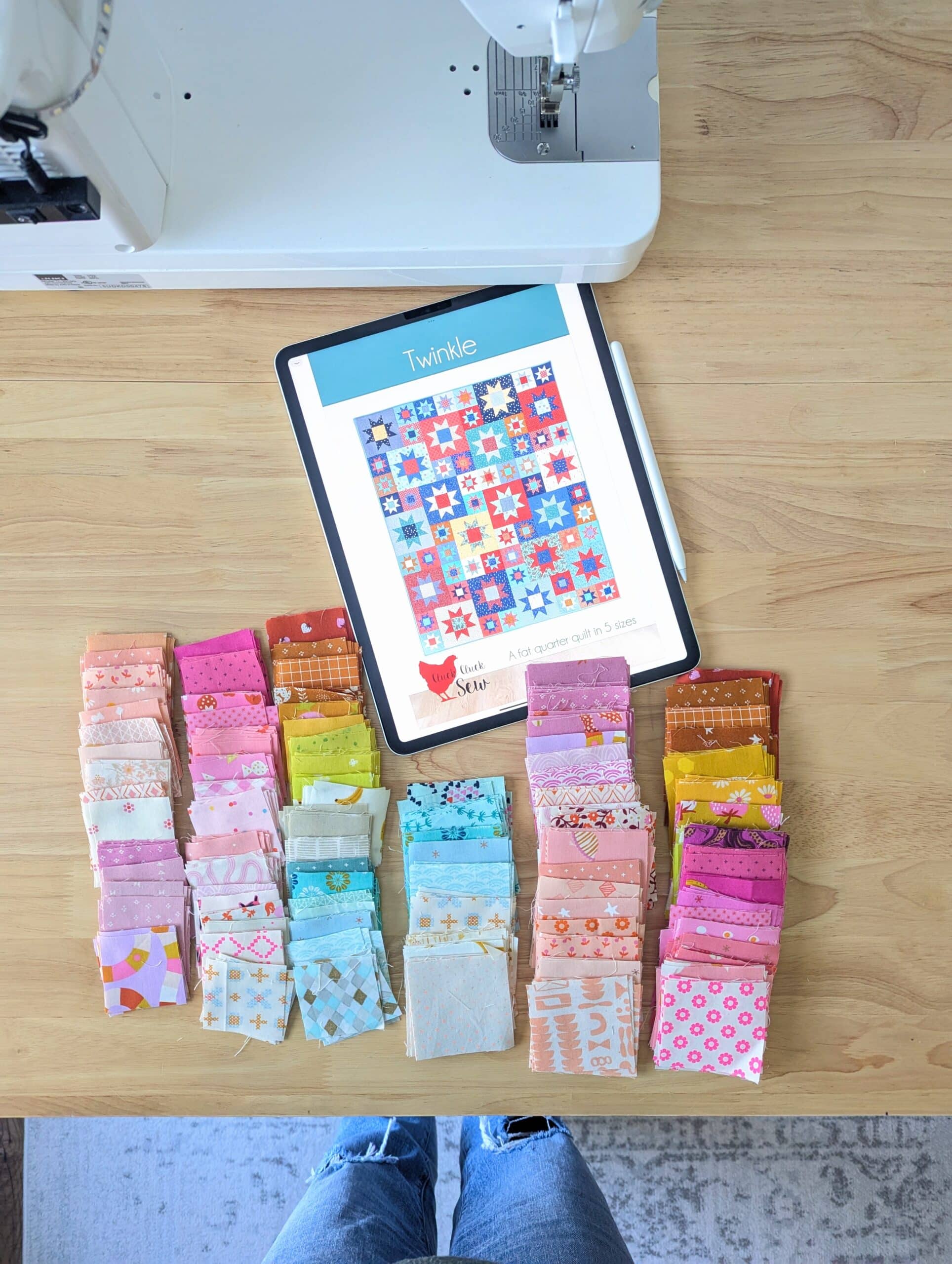 Fabric squares and iPad showing Twinkle quilt pattern cover.