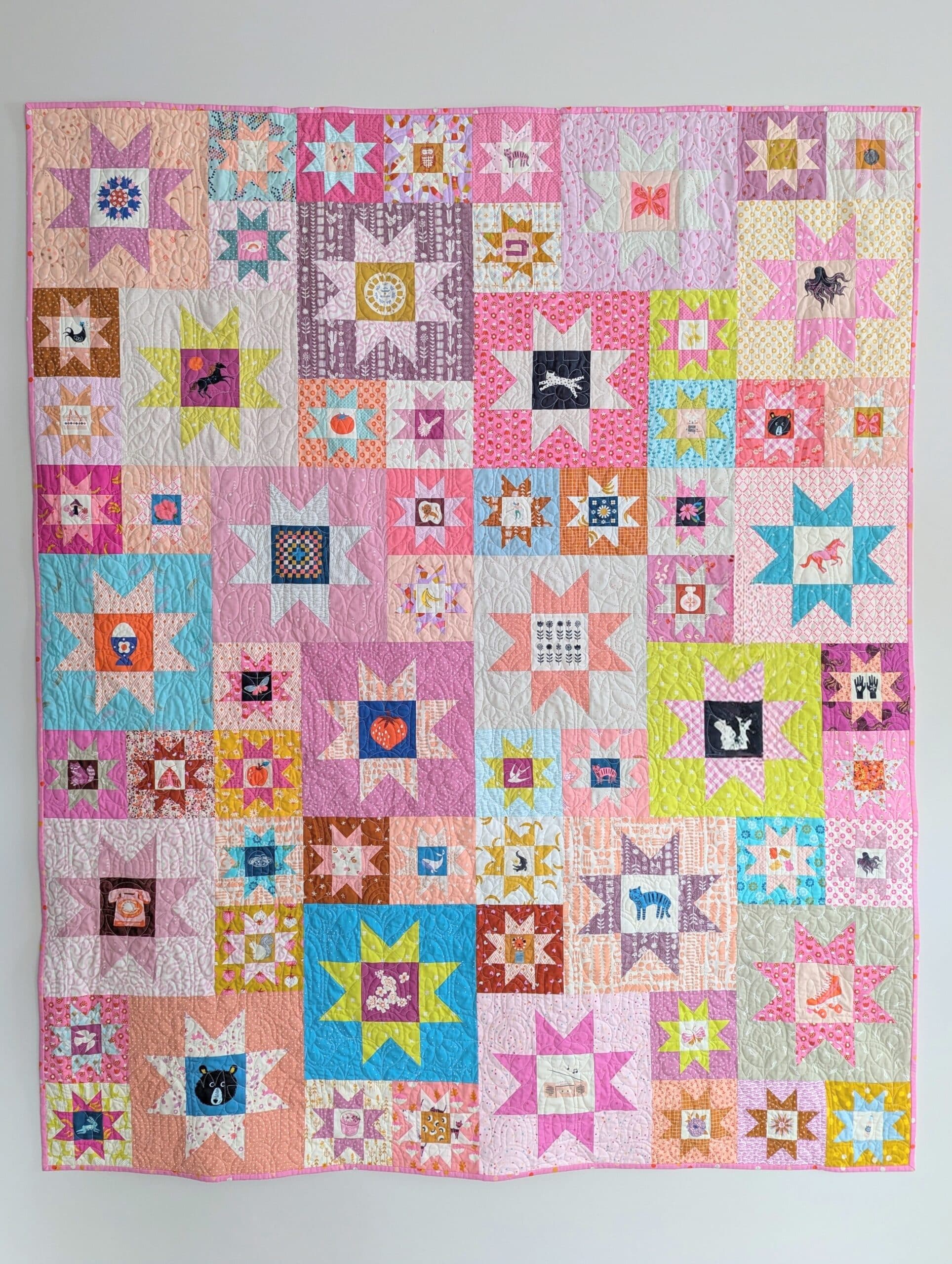 Completed quilt hangs on a wall.