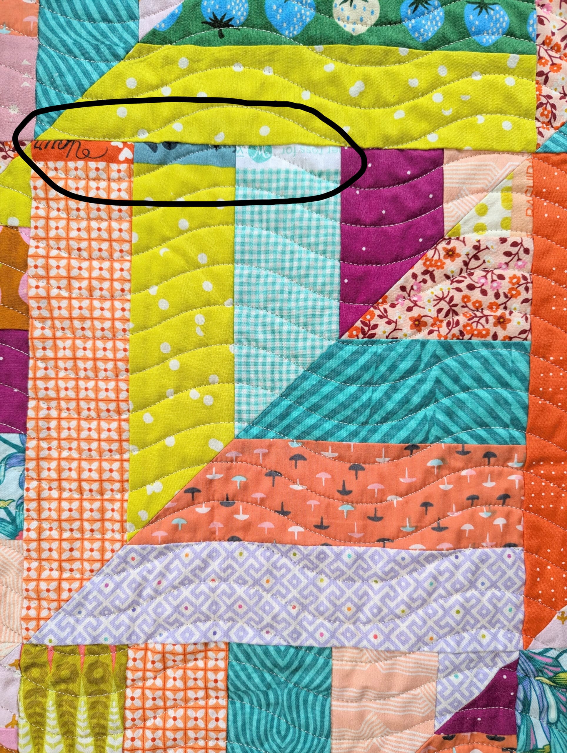 One quilt block containing several pieces of selvedge.