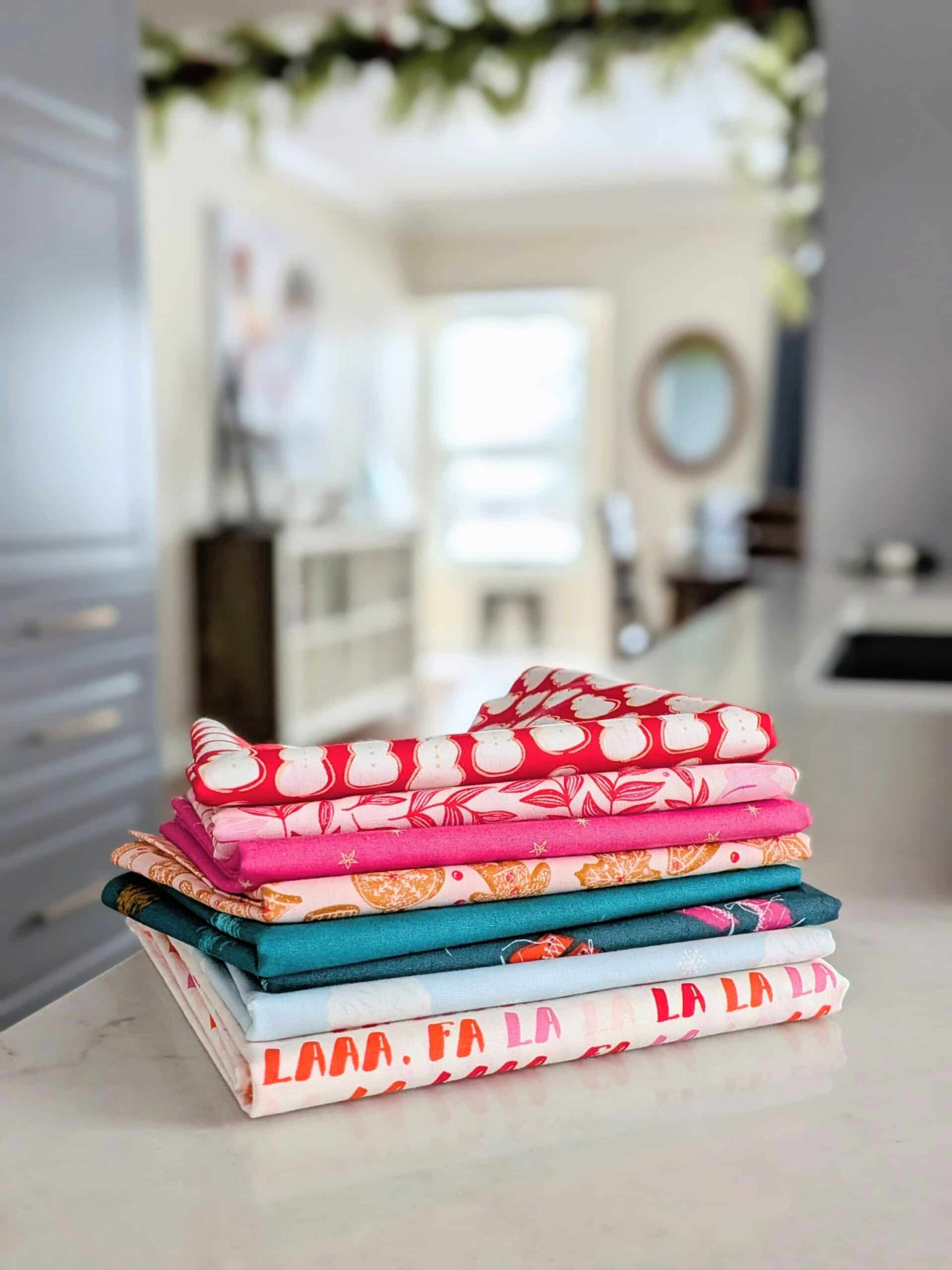 A small stack of fabric sits on a kitchen countertop.