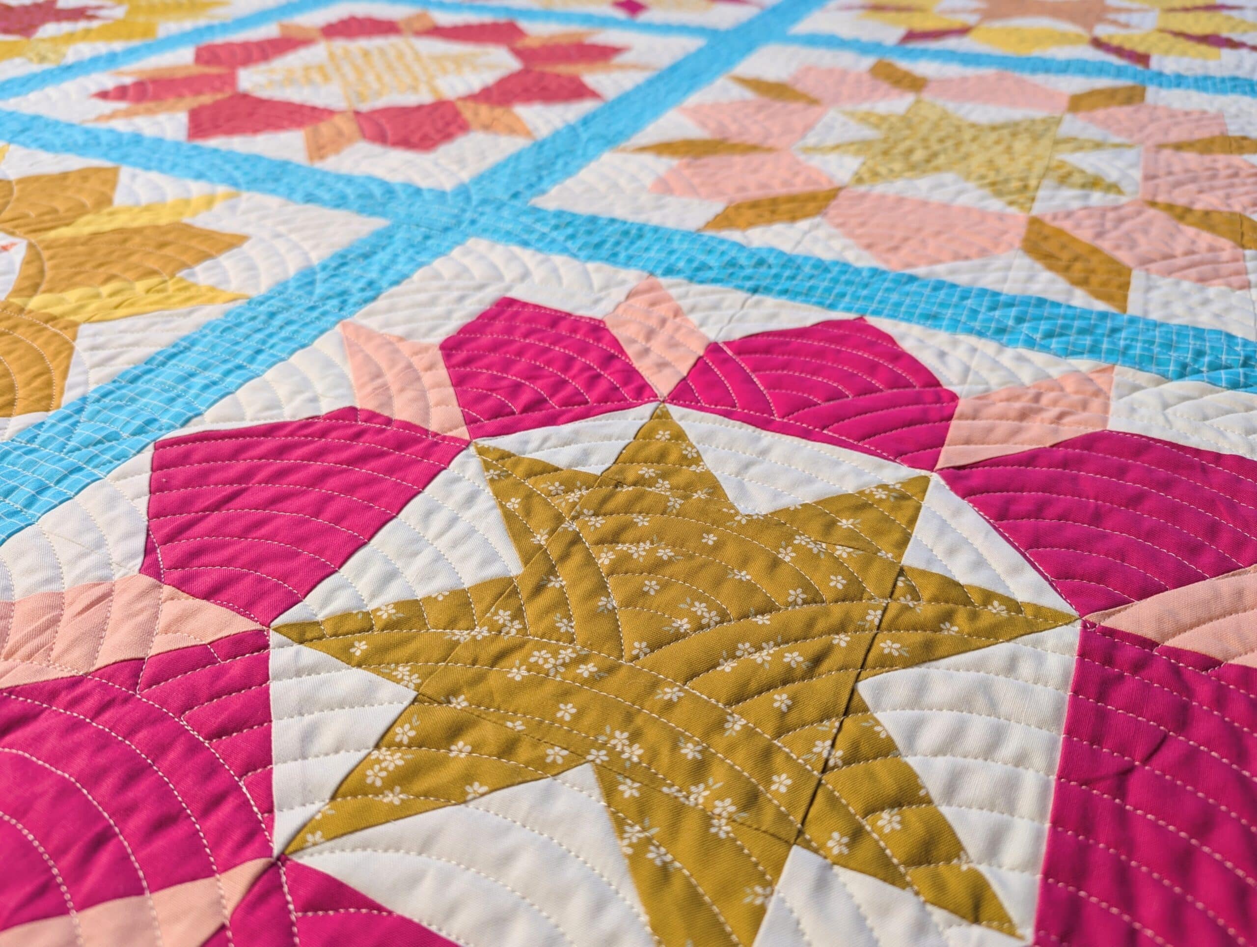 Wide angle of the bright and colourful quilt seen from a low angle.