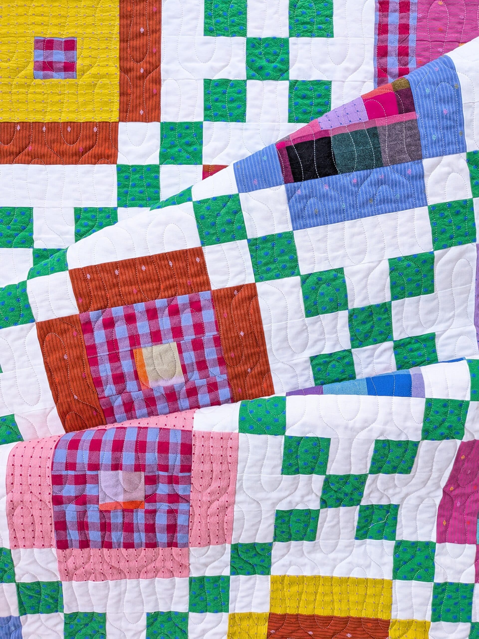 The finished quilt is folded onto itself twice.