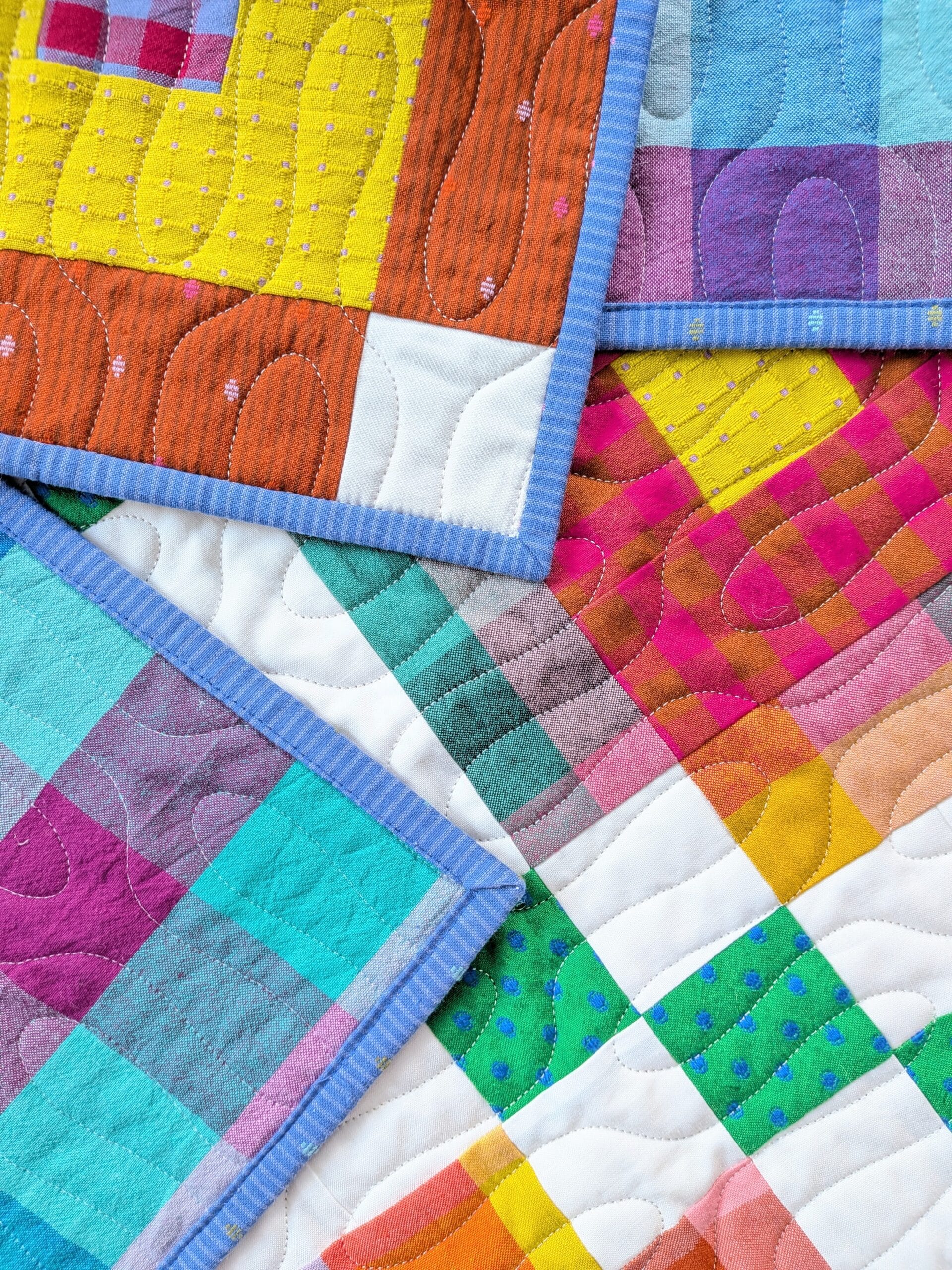 Two corners of the finished quilt are flipped over on the front of the quilt.