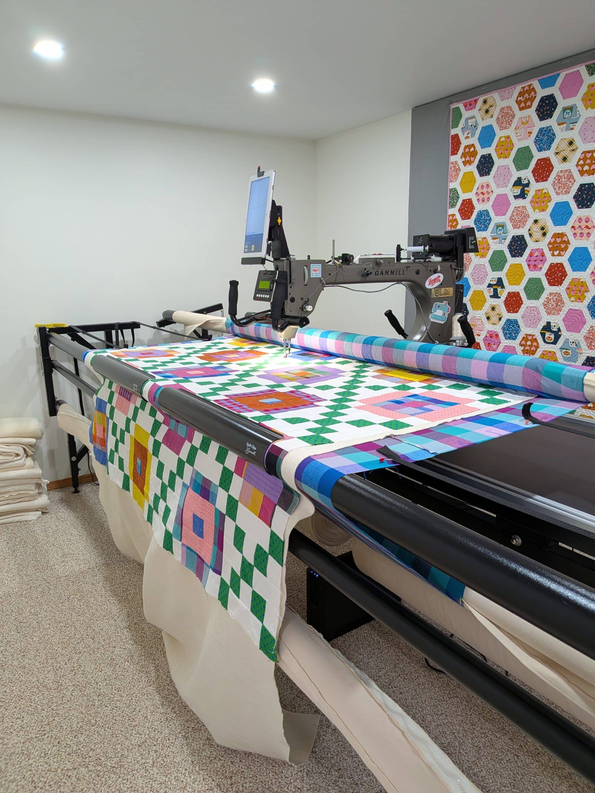 The quilt is loaded on a longarm machine.