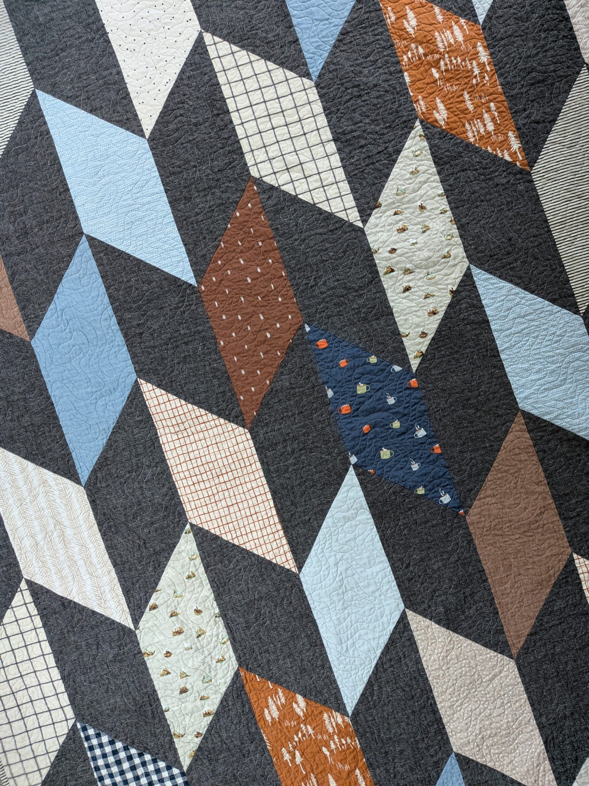 A chevron quilt is seen from overhead.