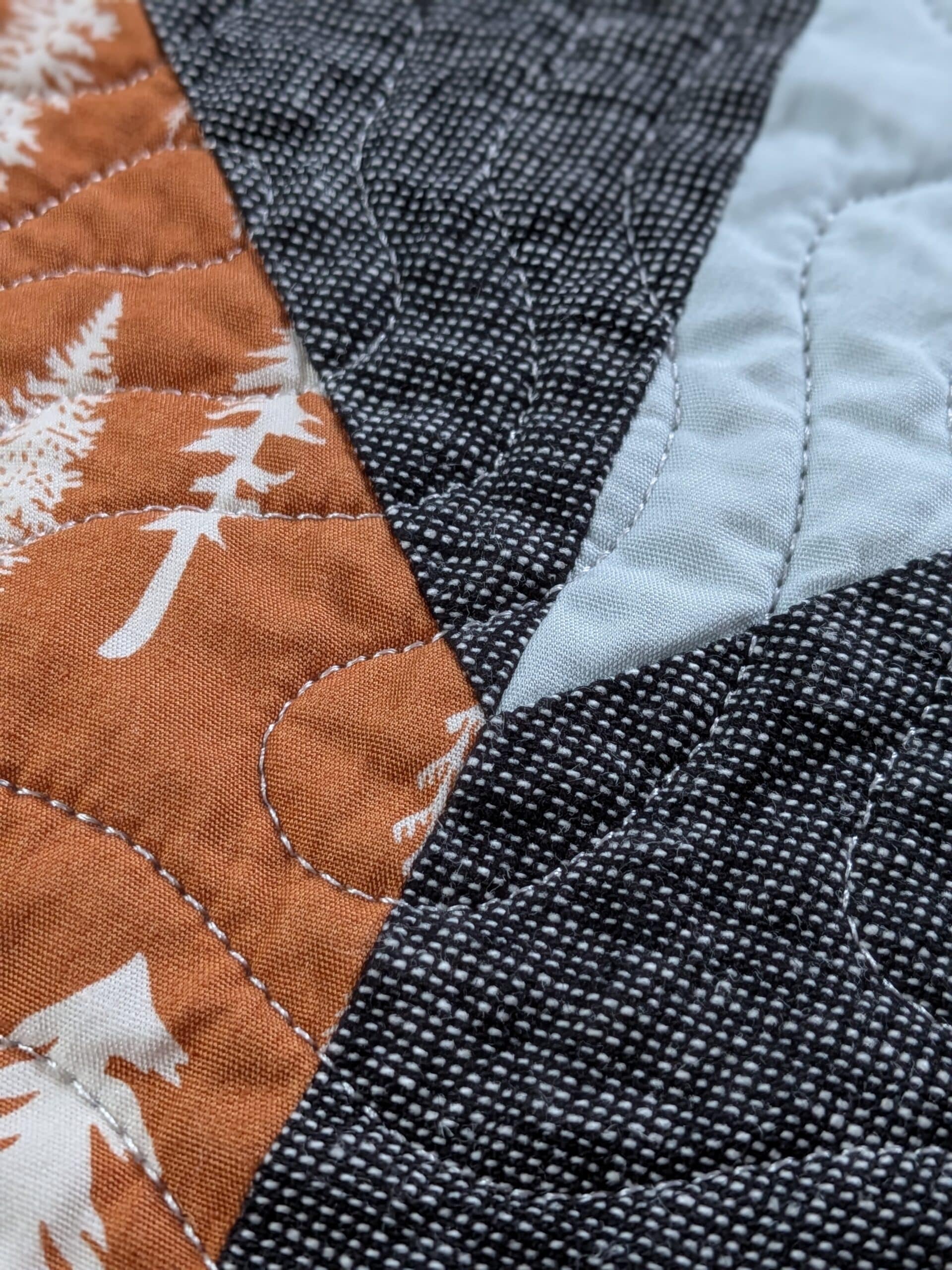 A closeup view of the stitching on a chevron quilt.
