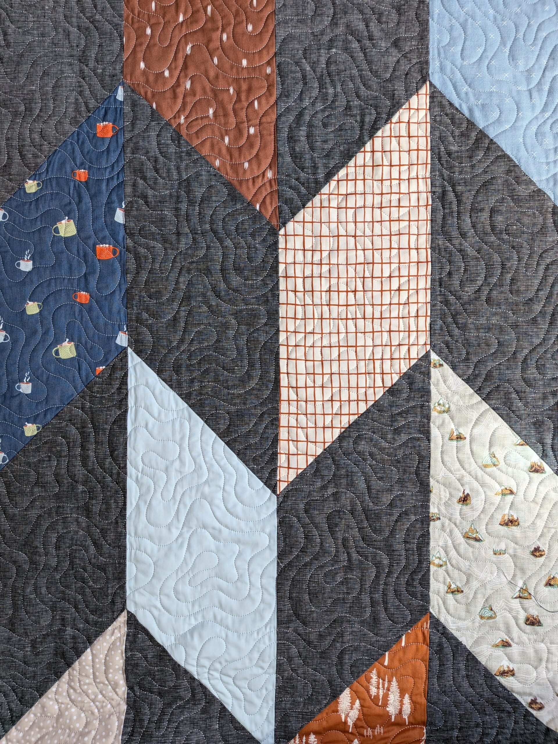 A chevron quilt is seen from an overhead view.
