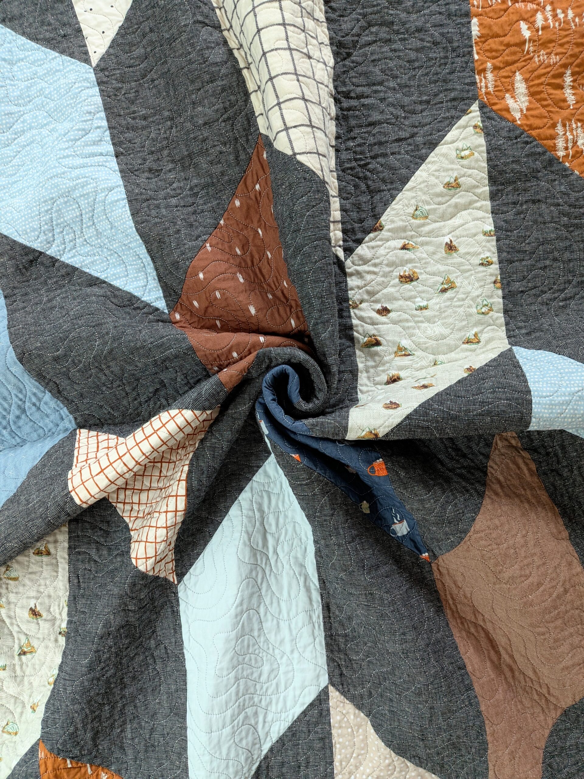A chevron quilt is swirled.